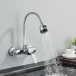 Modern kitchen faucet with flexible hose spraying water into a sink.