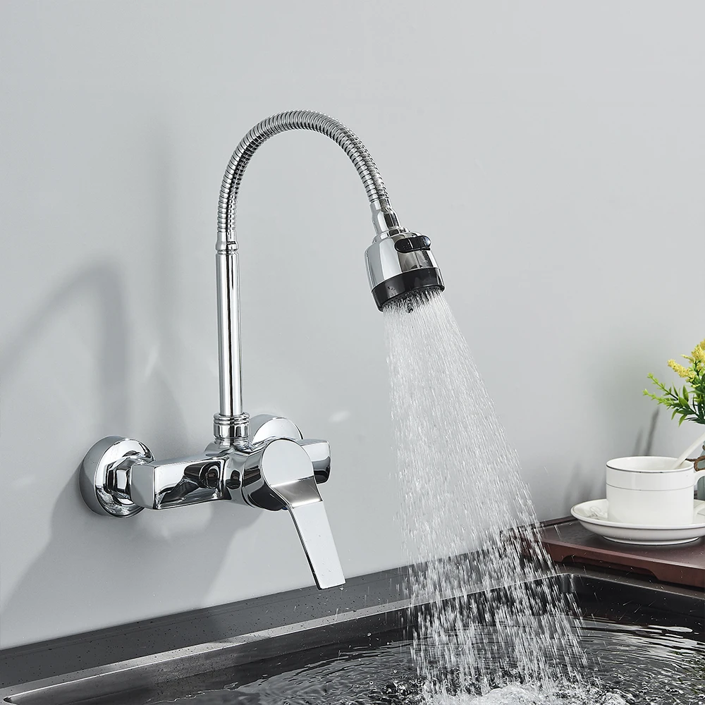 Modern kitchen faucet with flexible hose spraying water into a sink.