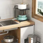 Kitchen corner with multi-tier pot racks and various pots.