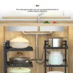 Under-sink storage shelves with various pots and pans.