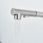 Modern stainless steel kitchen faucet with water flowing.
