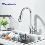 Modern kitchen faucet with running water over a sink.