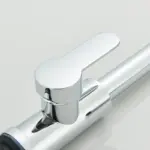 Close-up of a modern chrome faucet handle.