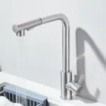 Modern stainless steel kitchen faucet with water flowing.