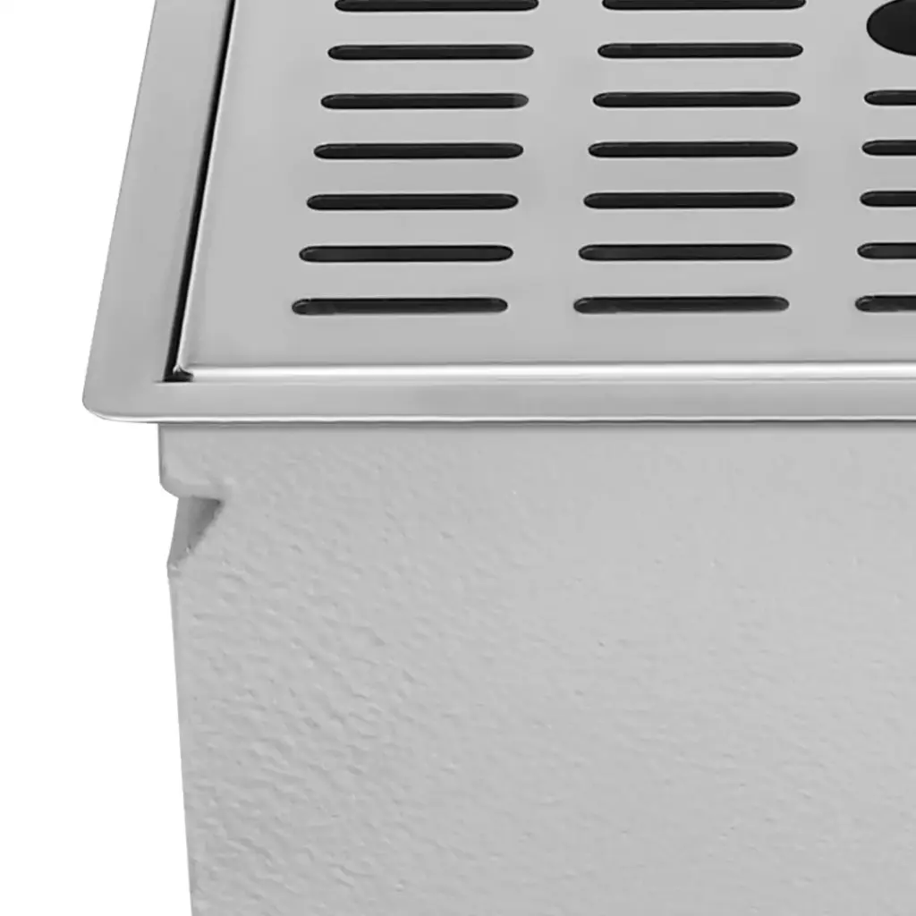 Close-up of a stainless steel drainage grate on a white surface.