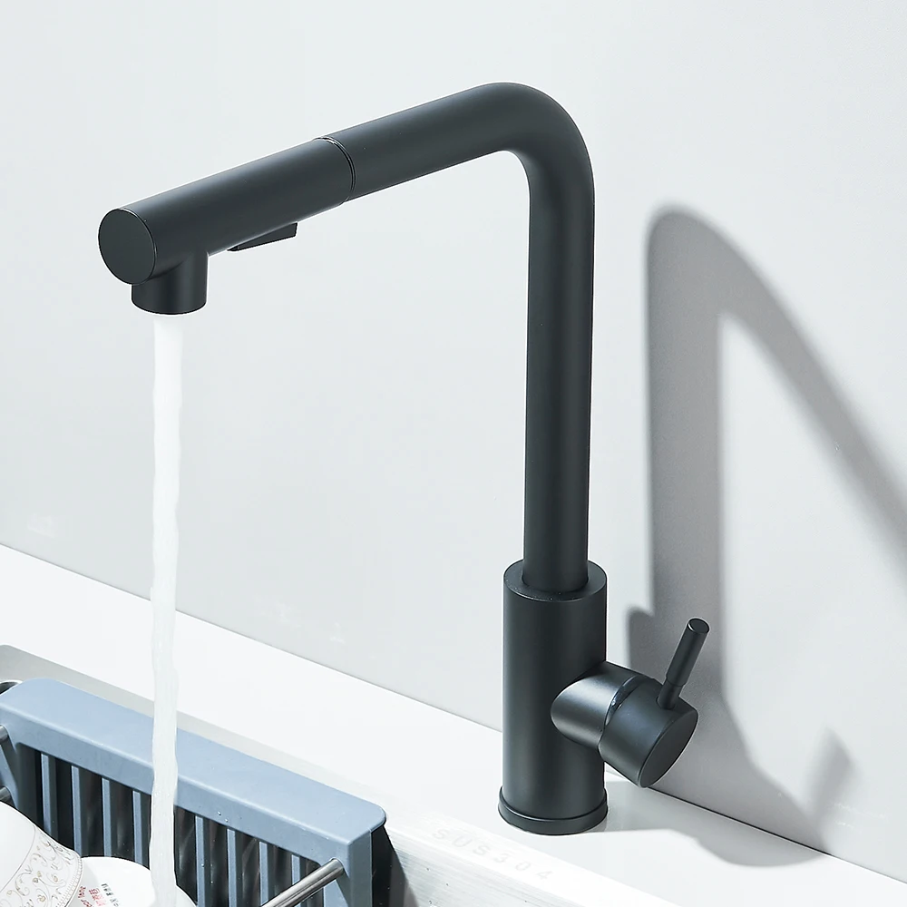 Modern black kitchen faucet with water flowing into a sink.