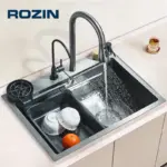 Modern kitchen sink with running water and dishes.