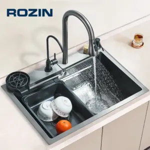 Modern kitchen sink with running water and dishes.