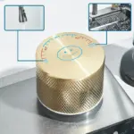 Close-up of a gold kitchen faucet knob with temperature settings.