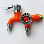 Orange garden faucet with metal connectors and a chrome handle.