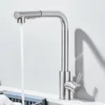 Modern stainless steel kitchen faucet with running water.