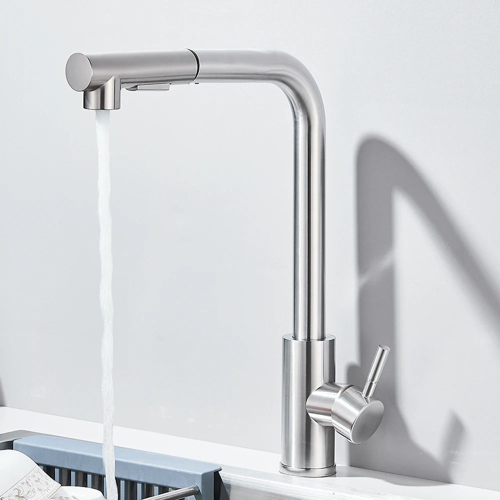 Modern stainless steel kitchen faucet with running water.