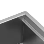 Close-up of a stainless steel kitchen sink corner